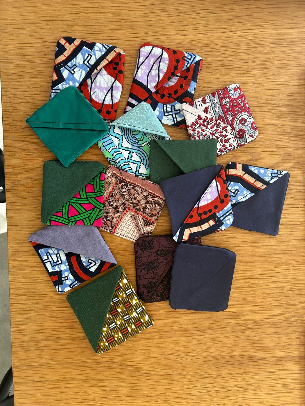 A pile of handcrafted corner bookmarks showing the variety of fabrics