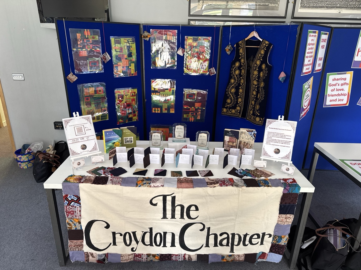The Croydon Chapter display at a school event with banner, products and donated cultural garment